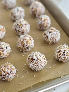 there are many coconut balls on the baking sheet