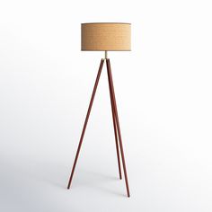 a wooden tripod floor lamp with a light shade on it's top and bottom