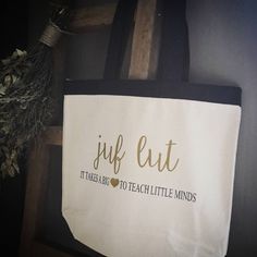 a tote bag hanging on a wall with the words jurf eat it takes four to teach little minds