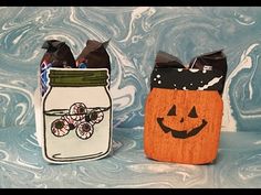 two halloween treat bags sitting next to each other