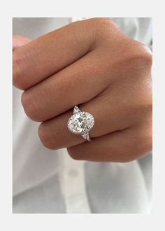 a woman's hand with a diamond ring on it