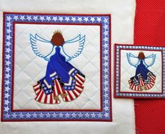 two quilted wall hangings with an american flag and angel design on them, one in blue and the other in red