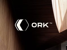 the logo for ork is shown in black and white on a wood paneled wall