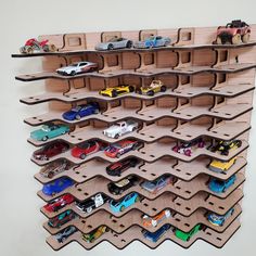 toy cars are lined up on wooden shelves to display them in the shape of hexagons