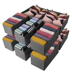 six bins filled with different colored clothes and one is open to show the folded ones