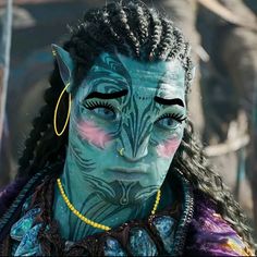 a woman with blue face paint and braids