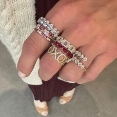 a woman's hand with three different rings on her left and two diamond ring on the right