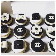 a box filled with black and white cupcakes