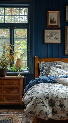 a bedroom with blue walls and pictures on the wall