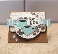 a card with two cups of coffee on it and the words for you above them