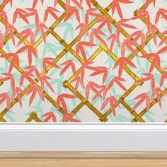 an abstract painting with gold and pink leaves on the wall next to a white door