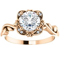 a gold ring with an oval cut diamond in the center and two small diamonds on each side