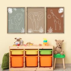 two children's art prints on the wall above a toy chest with bins