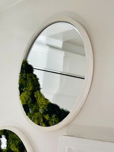 two circular mirrors are hanging on the wall