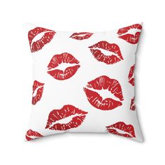 a white pillow with red lips on the front and back of it, all over