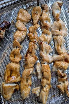 chicken wings are being cooked on a grill