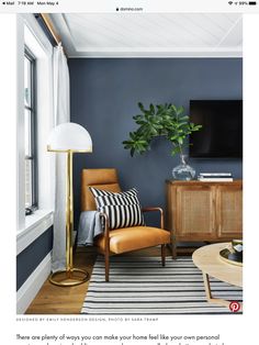 a living room with blue walls and wooden furniture