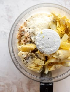 a food processor filled with pasta and seasoning