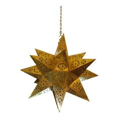 a brass star hanging from a chain