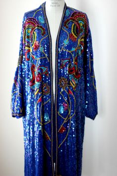 "Sooo beautiful!! by Judith Ann Creations This coat alone is amazing!! but ad the dress and you have an amazing set!! Rare to find them both and in Such amazing condition! The coat is in excellent condition..The embroidery is amazing..and oh soo beautiful!! Open and measuring: Length: 39\" Width: 60\" This coat is AMAZING and oh so rare Dress: This is charming and matches the coat. It is sleeveless and is in Very good condition, with a few missing beads..not noticeable. Measuring: 36\" long 38\" Vintage Sequined Outerwear For Spring, Spring Blue Beaded Outerwear, Vintage Winter Outerwear With Sequins, Luxury Blue Sequined Outerwear, Sequin Duster, Fitted Multicolor Sequined Outerwear, Rare Dress, Duster Jacket, Long Blazer