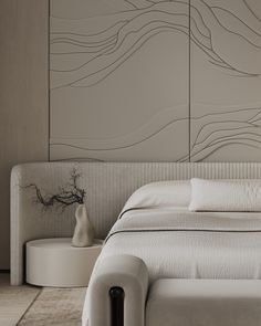 a white bed sitting in a bedroom next to a wall mounted art piece on it's side