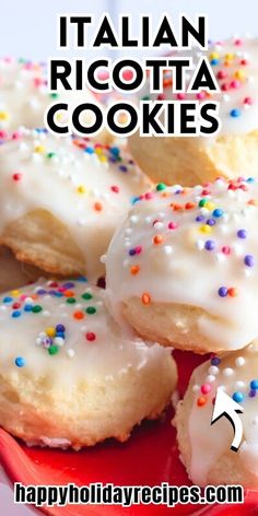 italian ricotta cookies with white icing and sprinkles on a red plate