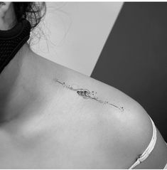 a woman with a tattoo on her shoulder