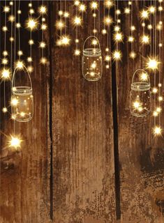 some mason jars with lights hanging from them on a wooden wall and the string is lit up