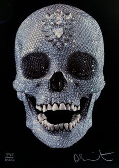 a skull with lots of diamonds on it's face and teeth is seen in this photograph