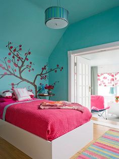 two pictures of a bedroom with blue walls and pink bedspreads, one has a tree painted on the wall