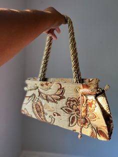 "ERA 2000s Y2K DESIGNER  Unknown COLOR Taupe Base Color with Browns, Bronzes and Creams MATERIALS  Unknown SIZE Height about 7\" Width 15.6\" DESCRIPTION  One of a Kind Tapestry Bag Beaded Enlarged Floral and Paisley Design Lightly Shimmery Fabric Bronze Beaded Accents Gorgeous Detailed Rope Handles CONDITION Grade: Great Vintage Condition  💋Please See our Grading Scale Under Shop Policies 💋Culture and Collection does NOT accept returns. Please review shop policies and grading scale prior to p Tapestry Bag, Vintage Purse, Rope Handles, Paisley Design, Base Colour, Purses And Handbags, Paisley, Vintage Fashion, Tapestry