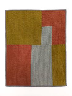 an orange, yellow and grey rug with squares on it's sides in different colors