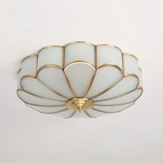 a white and gold light fixture on a wall