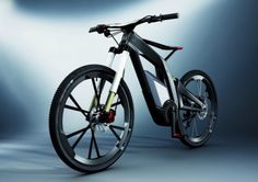 an electric bike is shown in front of a gray background with light coming from behind it