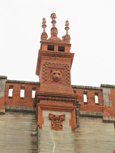 an old brick building with a clock on the front and side of it's face