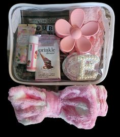 a pink bow tie and other items in a plastic container