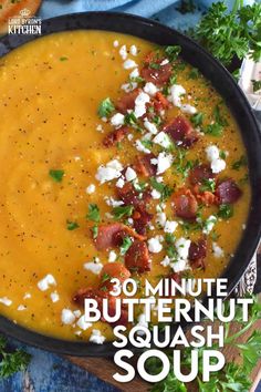 a bowl of butternut squash soup with bacon and feta cheese in the middle