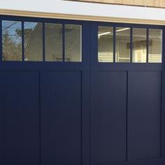 a blue garage door with windows on the side