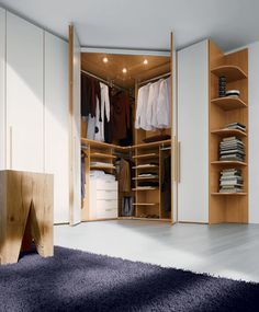 an open closet with clothes and other items in it