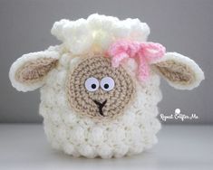 a crocheted sheep with a pink bow on it's head and eyes