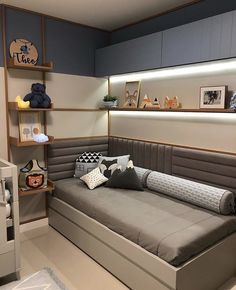 a bed room with a neatly made bed and shelves