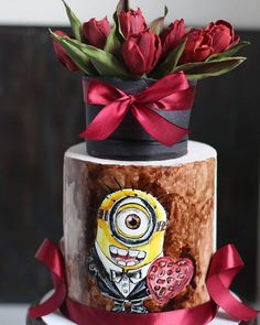 a decorated cake with flowers and a minion on it