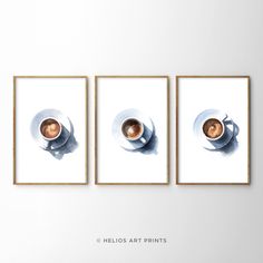 three framed pictures hanging on the wall above a couch with a coffee cup and saucer