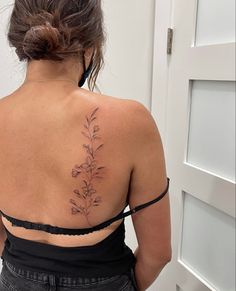 a woman with a flower tattoo on her back