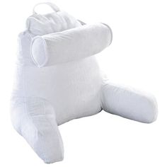 a large white stuffed animal sitting on top of a floor cushion with its arms spread out