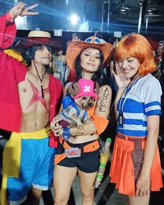 three people in costumes posing for the camera