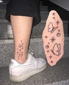 a woman's foot with a tattoo on it next to a pair of shoes