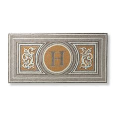 a decorative door mat with the letter h on it