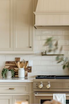 a kitchen with white cabinets and an oven