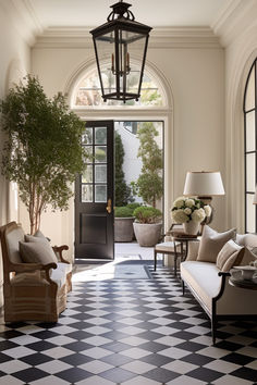 an entryway with black and white checkered flooring, two couches and a lamp